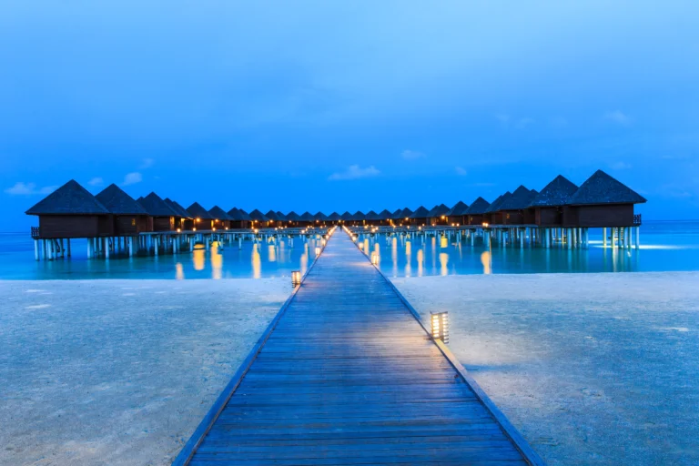 Tropical beach in Maldives with turquoise water and palm trees